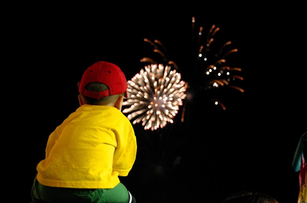Child watches fireworks display.